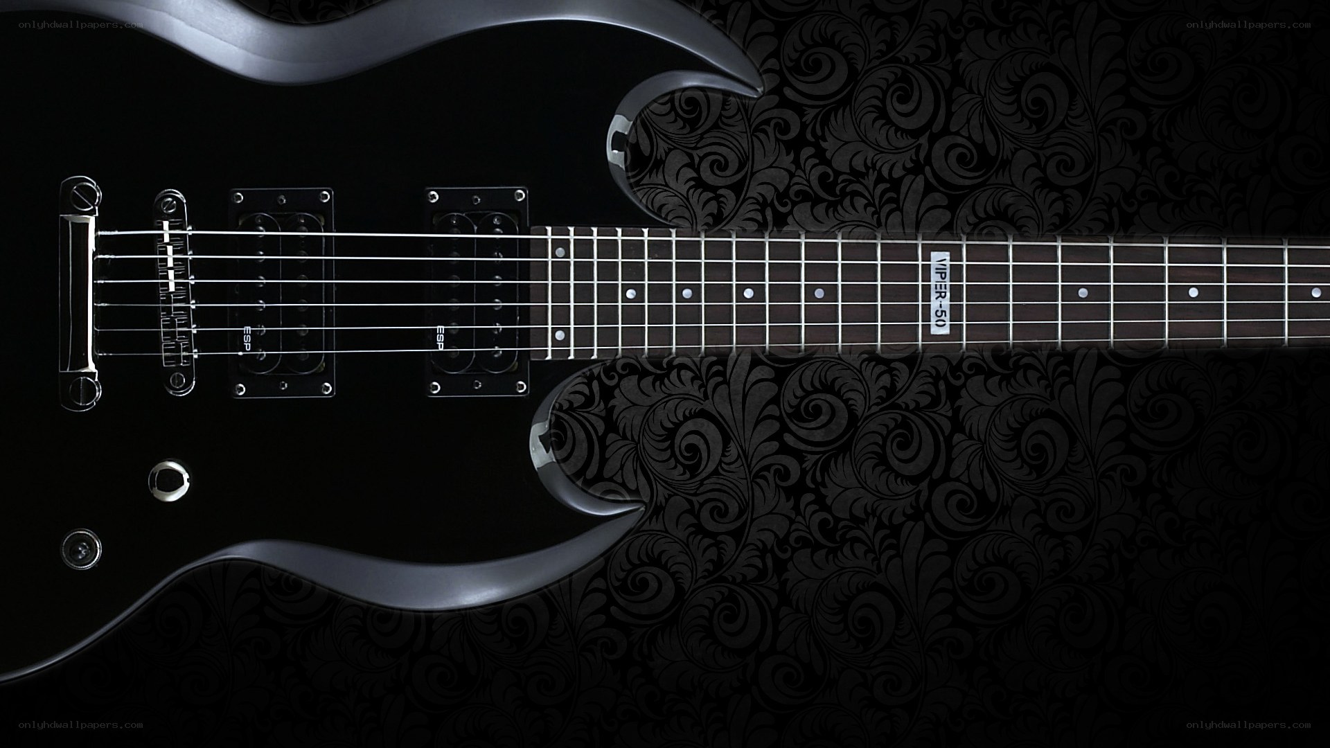 black electric guitar on patterned background