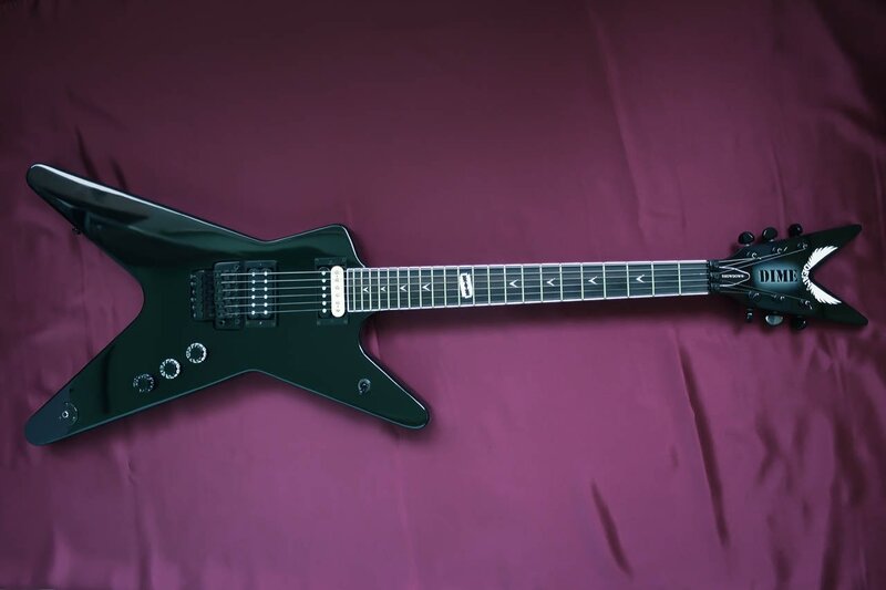 black electric guitar on purple cloth