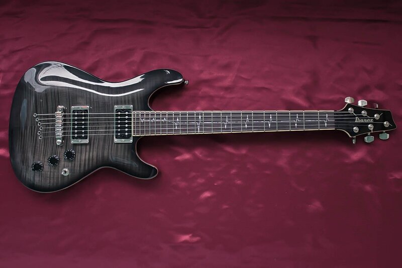 black electric guitar on red cloth
