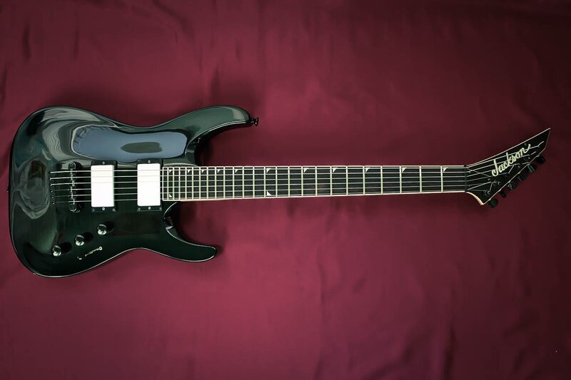 black electric guitar on red cloth