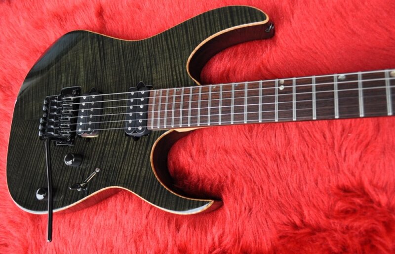 black electric guitar on red fur