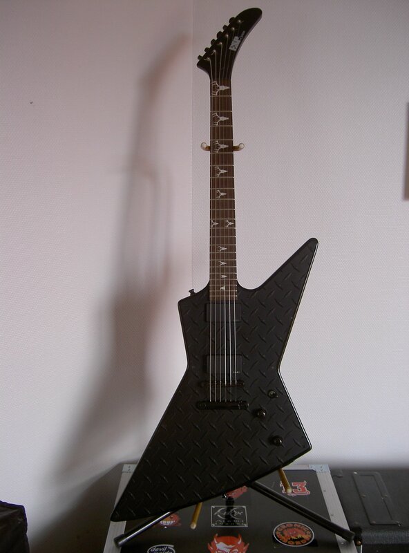 black electric guitar on stand