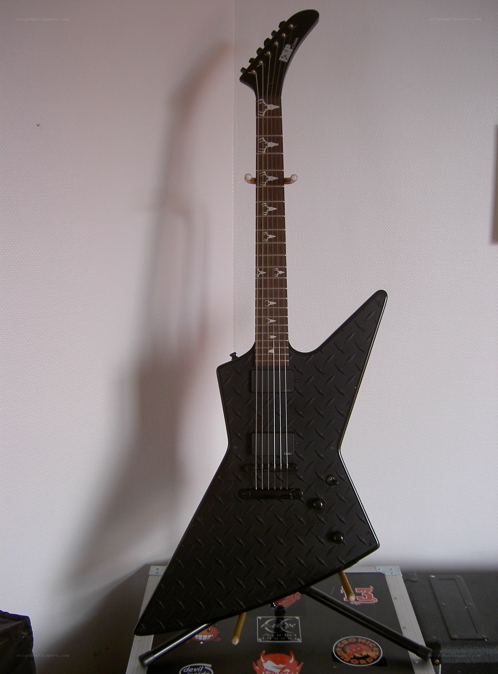 black electric guitar on stand