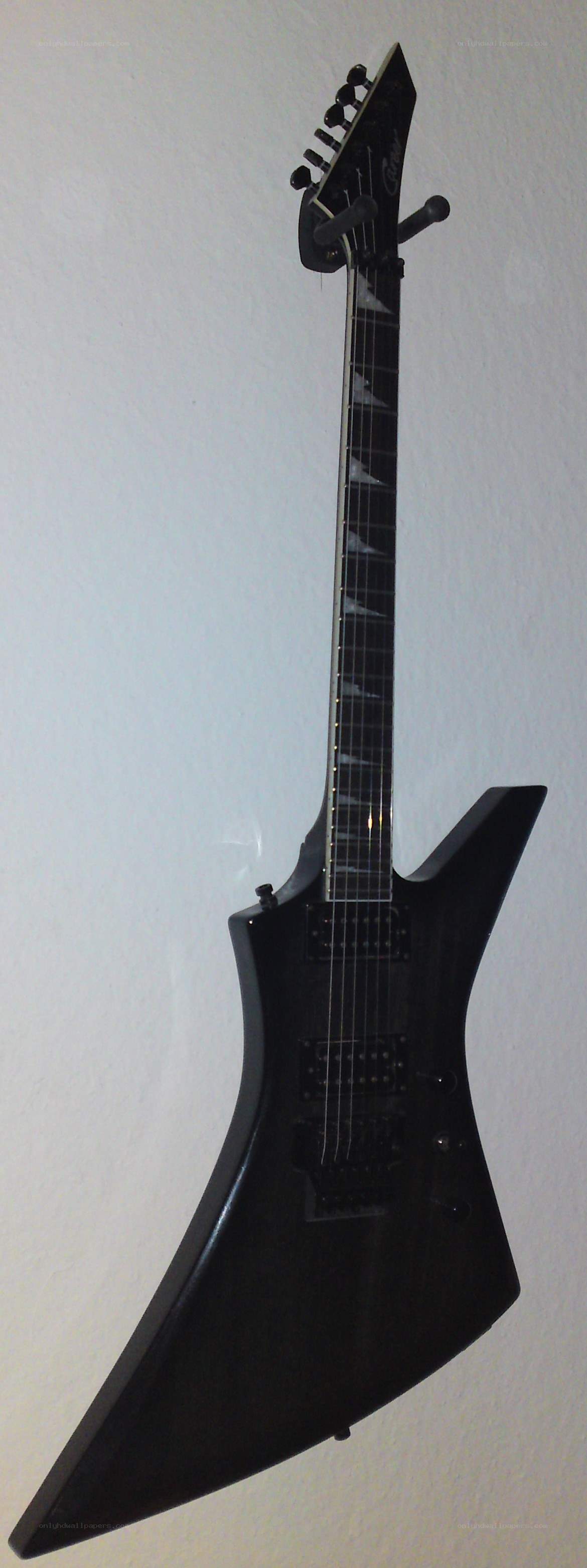 black electric guitar on wall