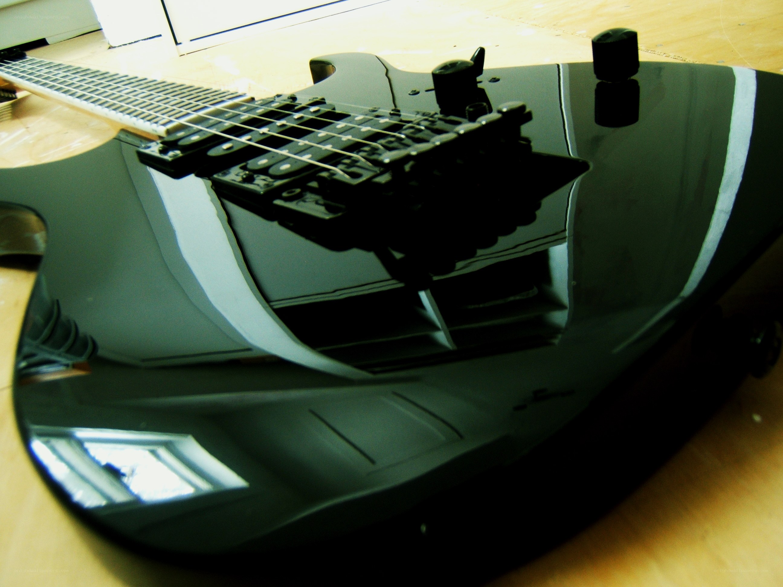 black electric guitar on wood
