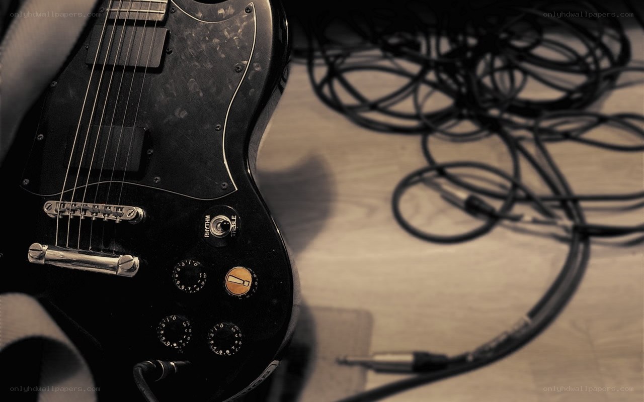 black electric guitar with cables