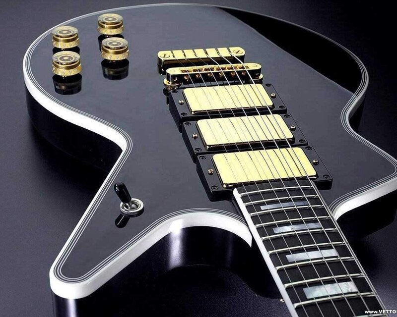 black electric guitar with gold hardware