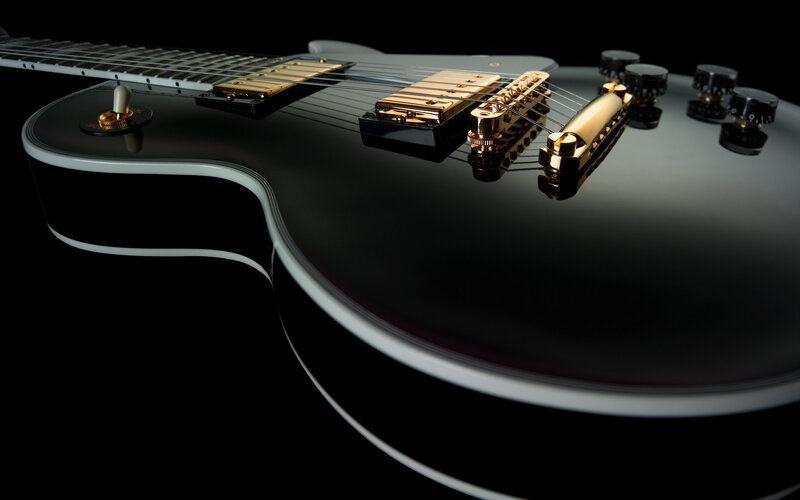 black electric guitar with gold hardware