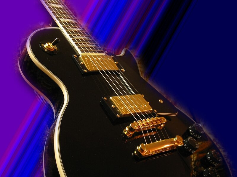 black electric guitar with gold hardware