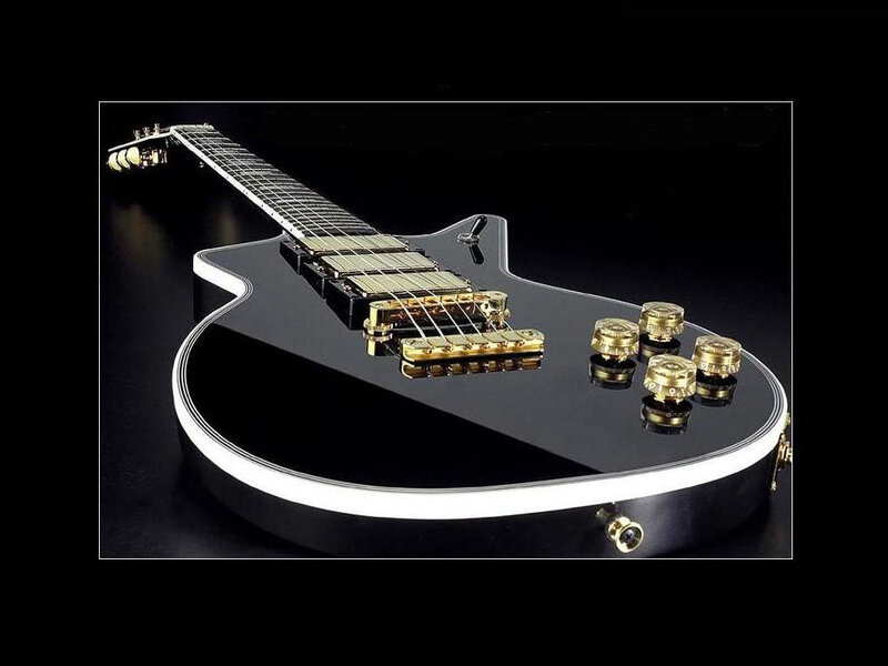 black electric guitar with gold hardware