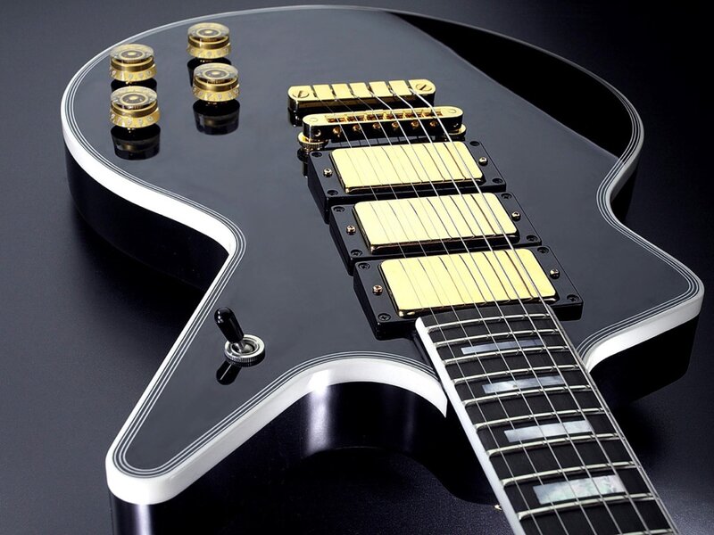 black electric guitar with gold hardware