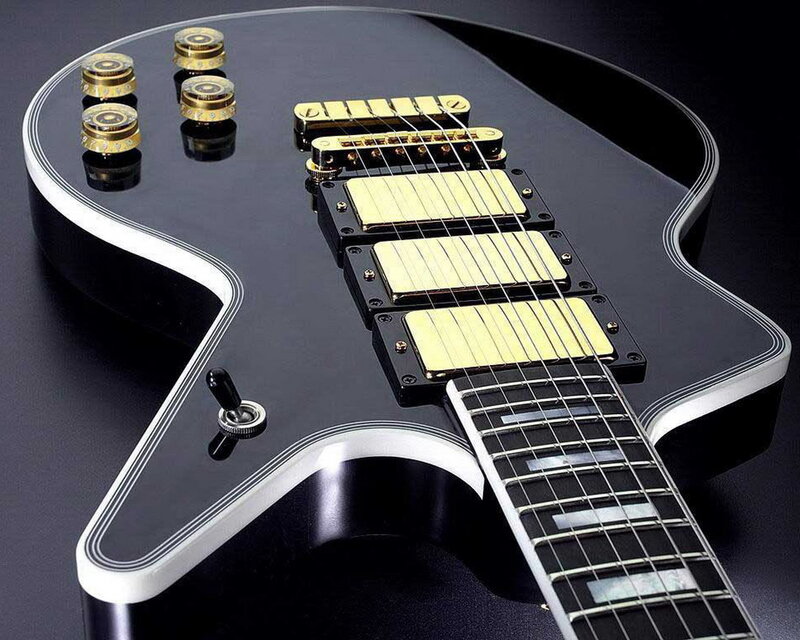 black electric guitar with gold hardware
