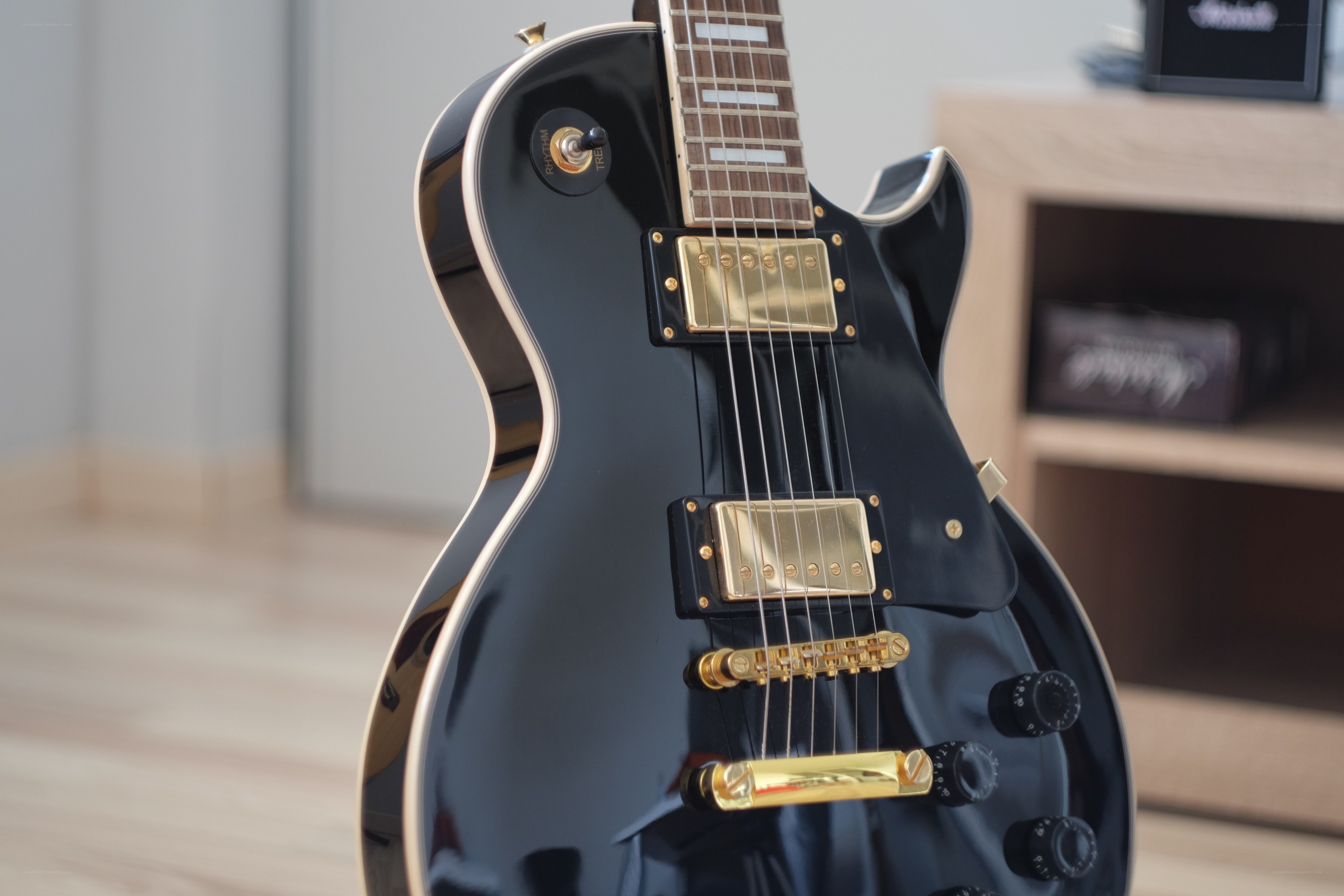 black electric guitar with gold hardware