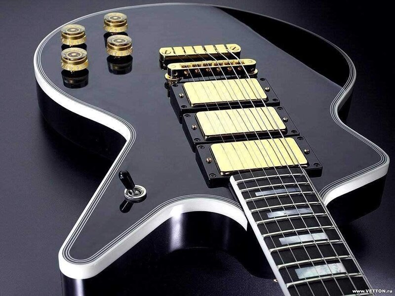 black electric guitar with gold pickups