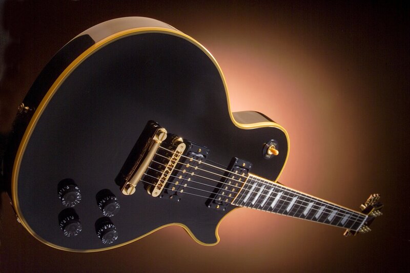 black electric guitar with gold trim
