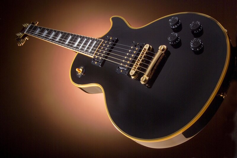 black electric guitar with gold trim