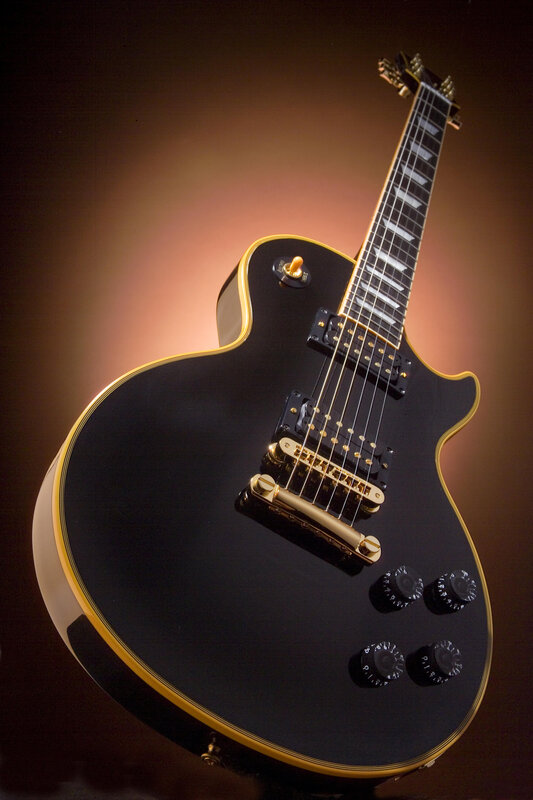 black electric guitar with gold trim