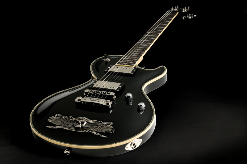 black electric guitar with skull emblem