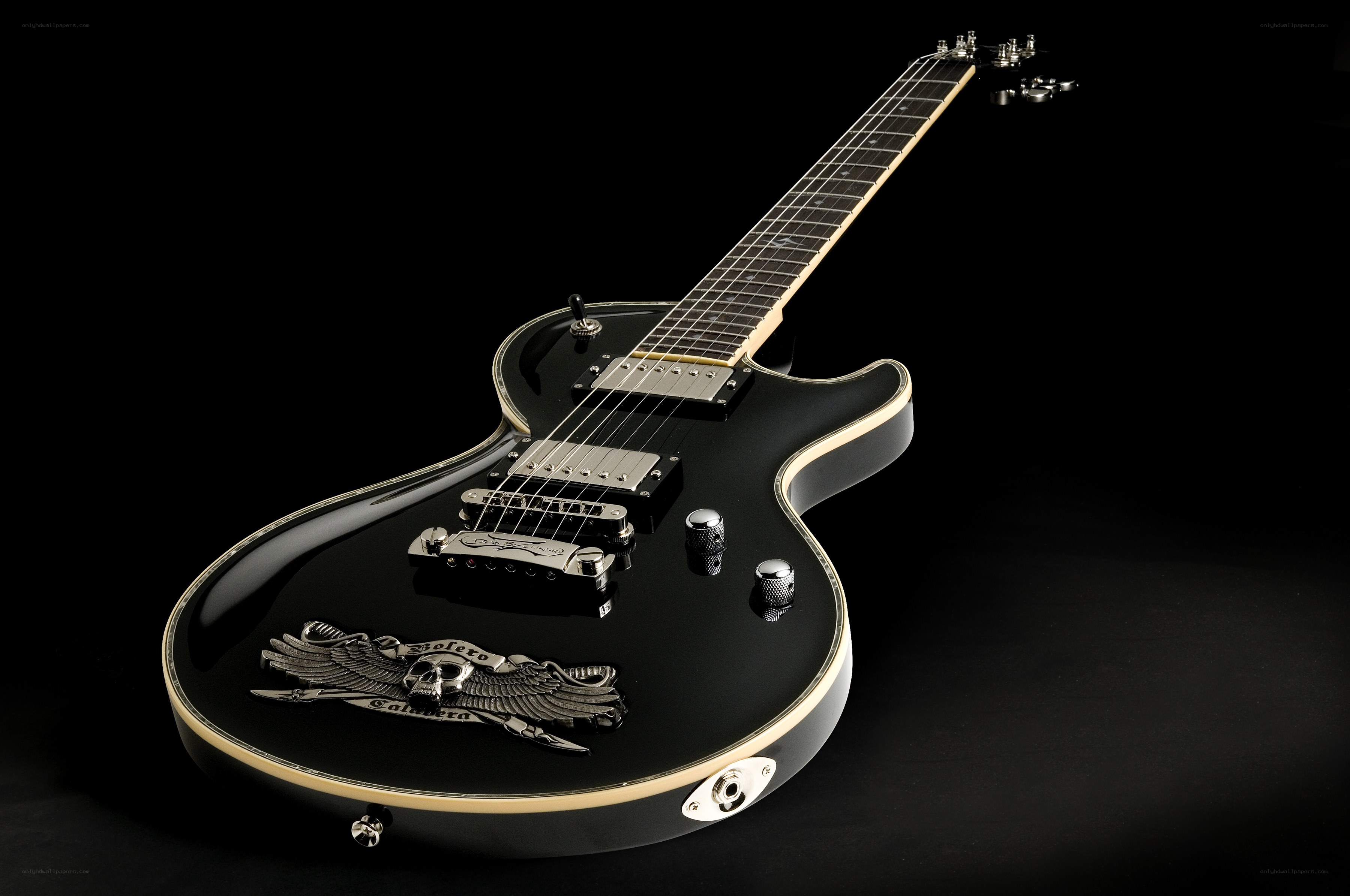 black electric guitar with skull emblem