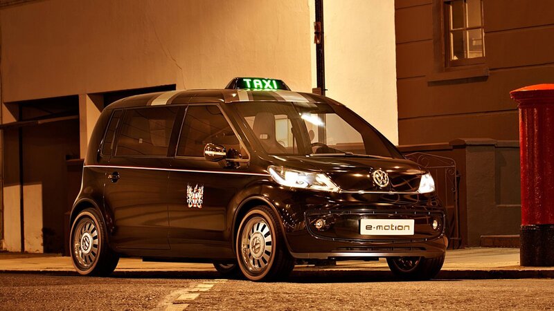 Black electric taxi on city street