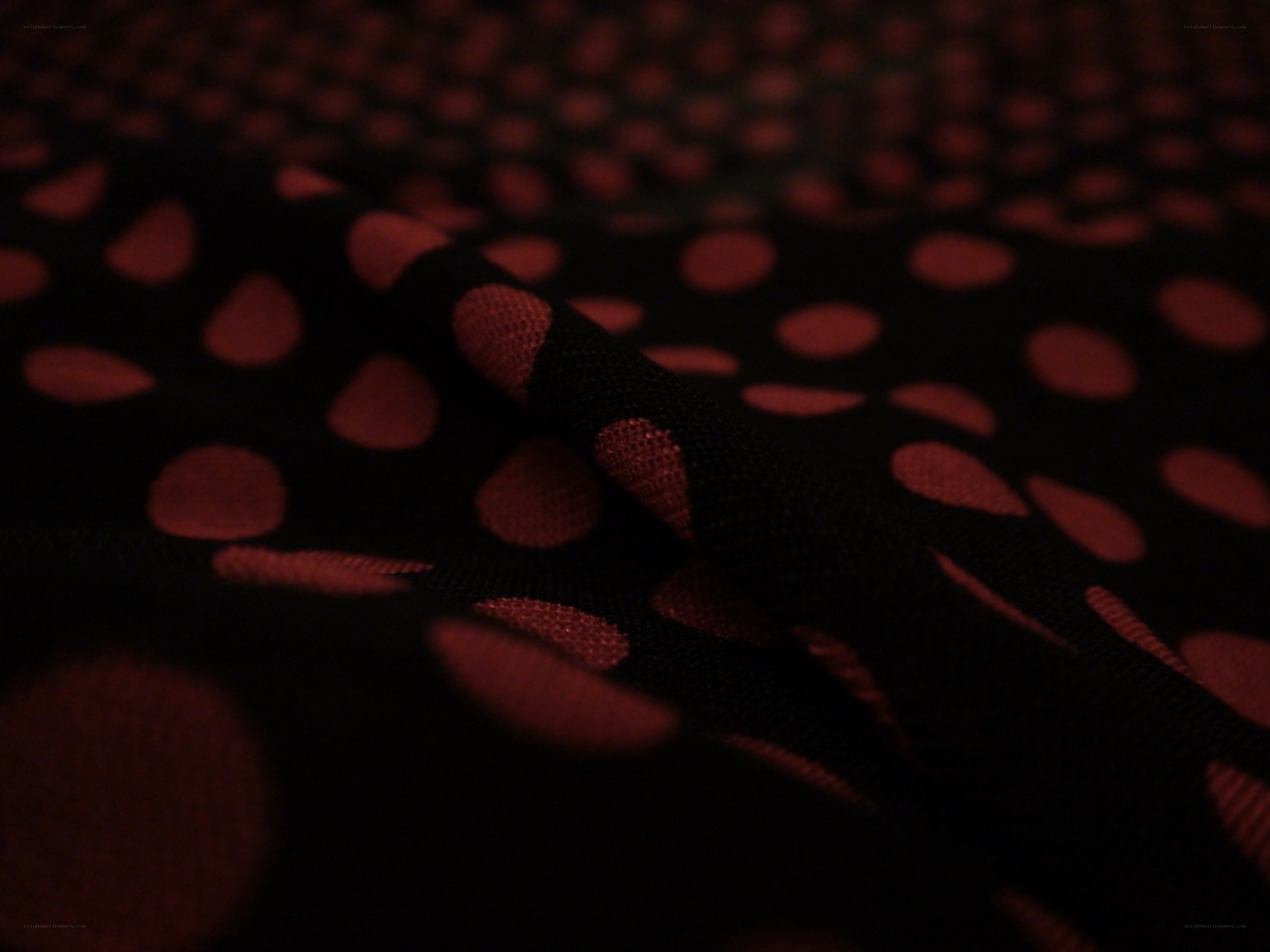 black fabric with red polka dots