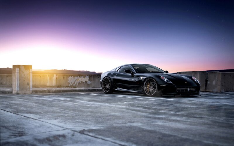 black ferrari at sunset