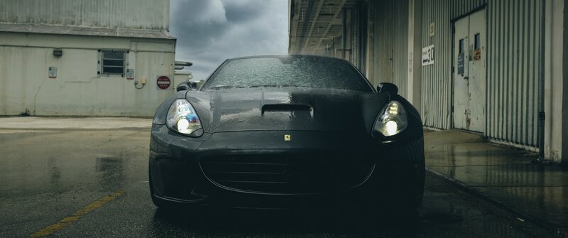 Black Ferrari Car — Dramatic, Photograph, Building