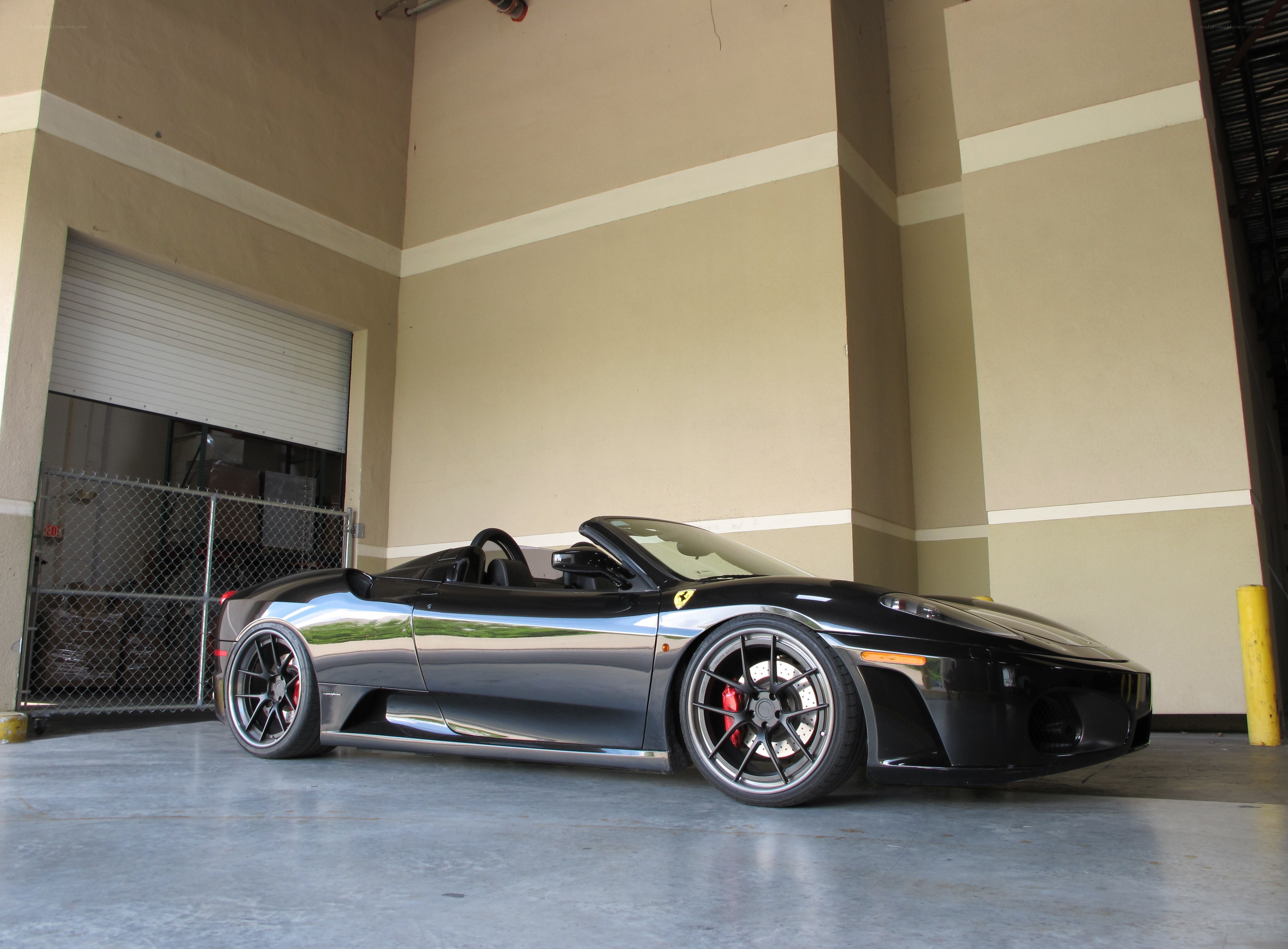 Black Ferrari convertible in garage
