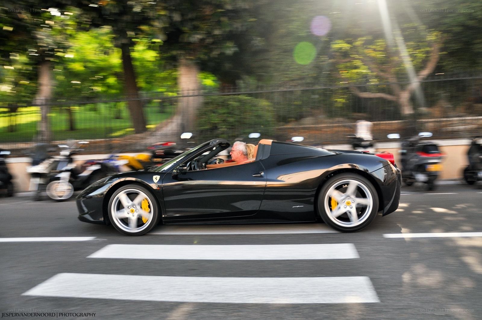 Black Ferrari convertible in motion