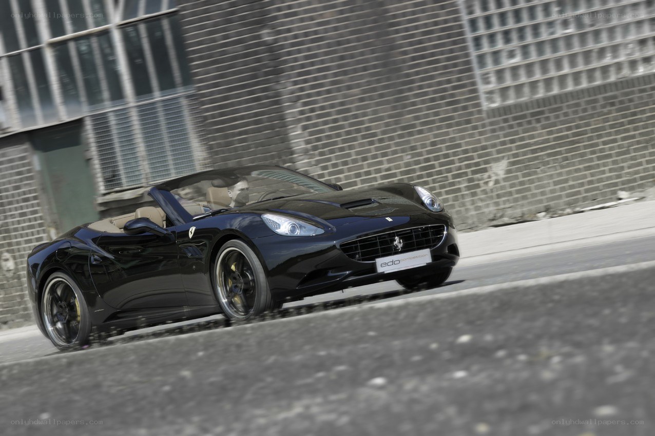 Black Ferrari convertible in motion