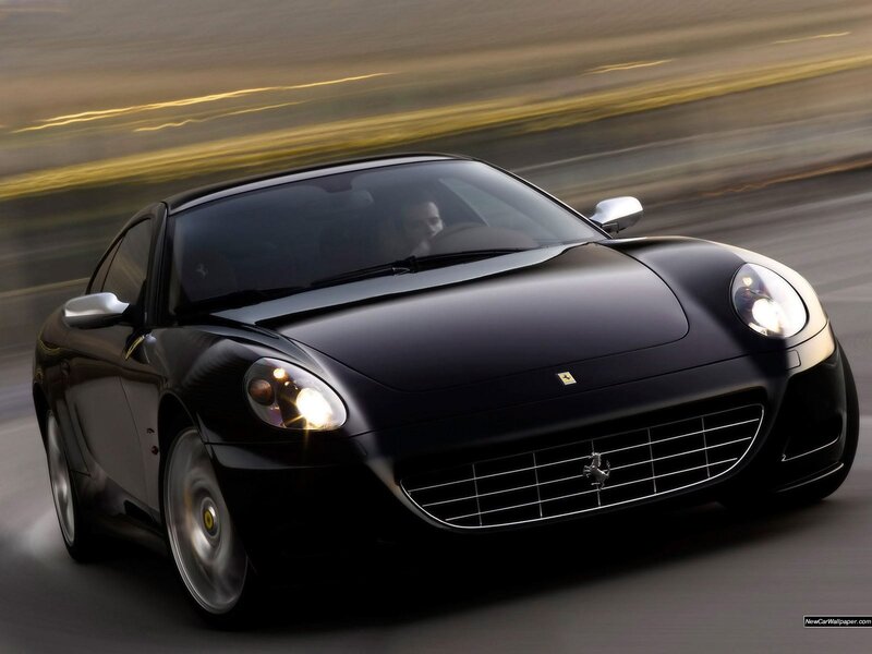 Black Ferrari driving fast