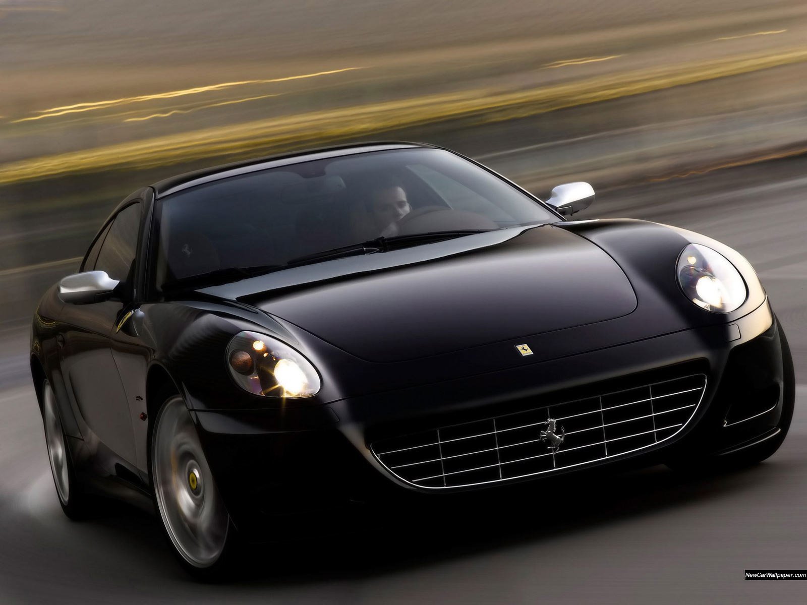 Black Ferrari driving fast