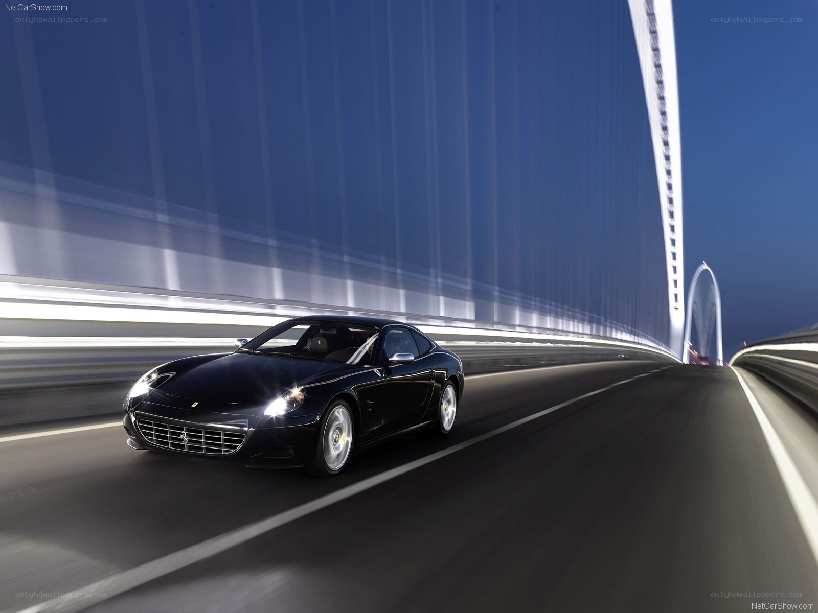Black Ferrari driving on a bridge