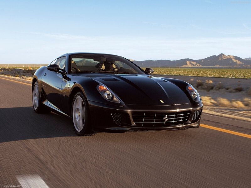 Black Ferrari driving on desert road