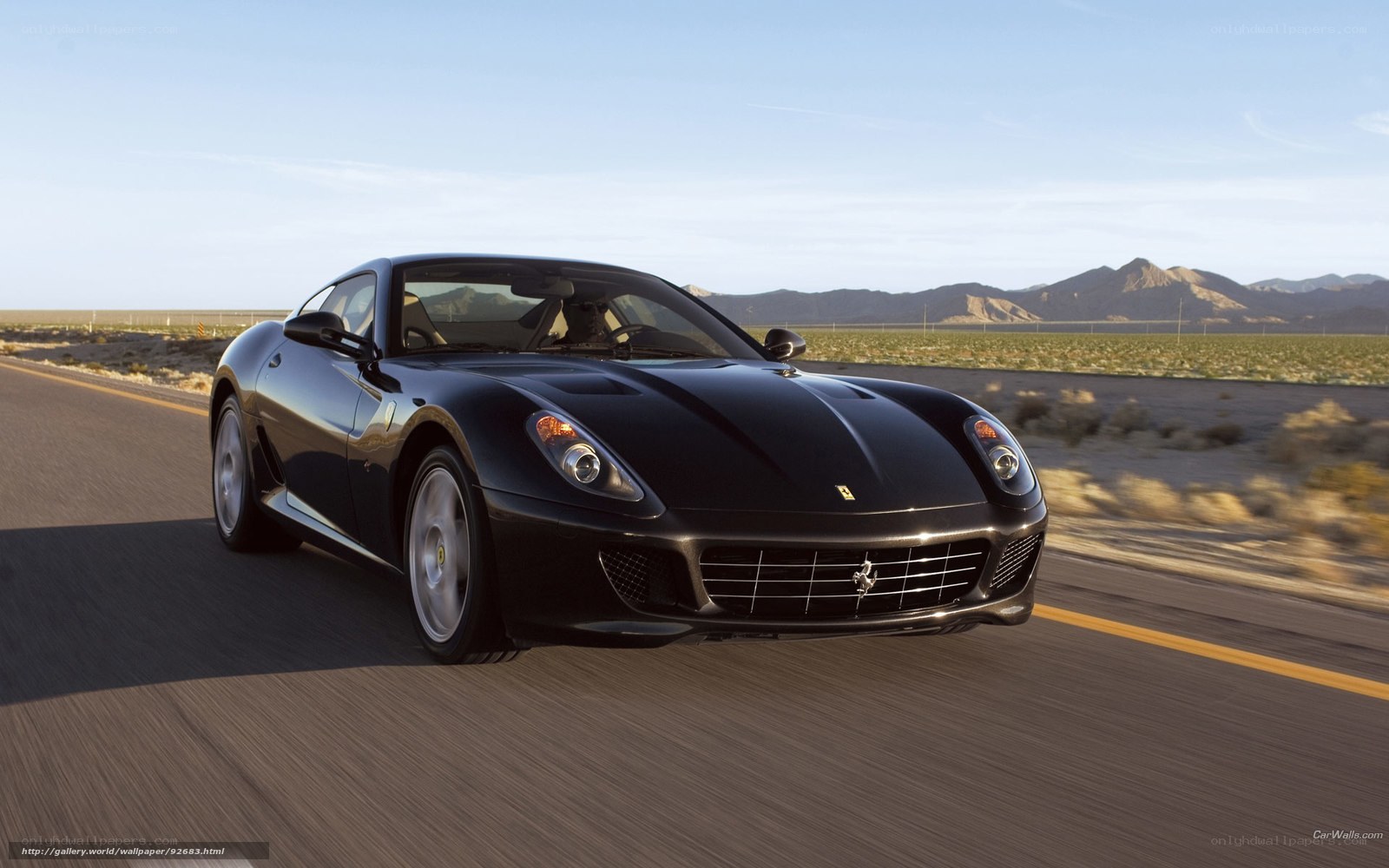 Black Ferrari driving on desert road