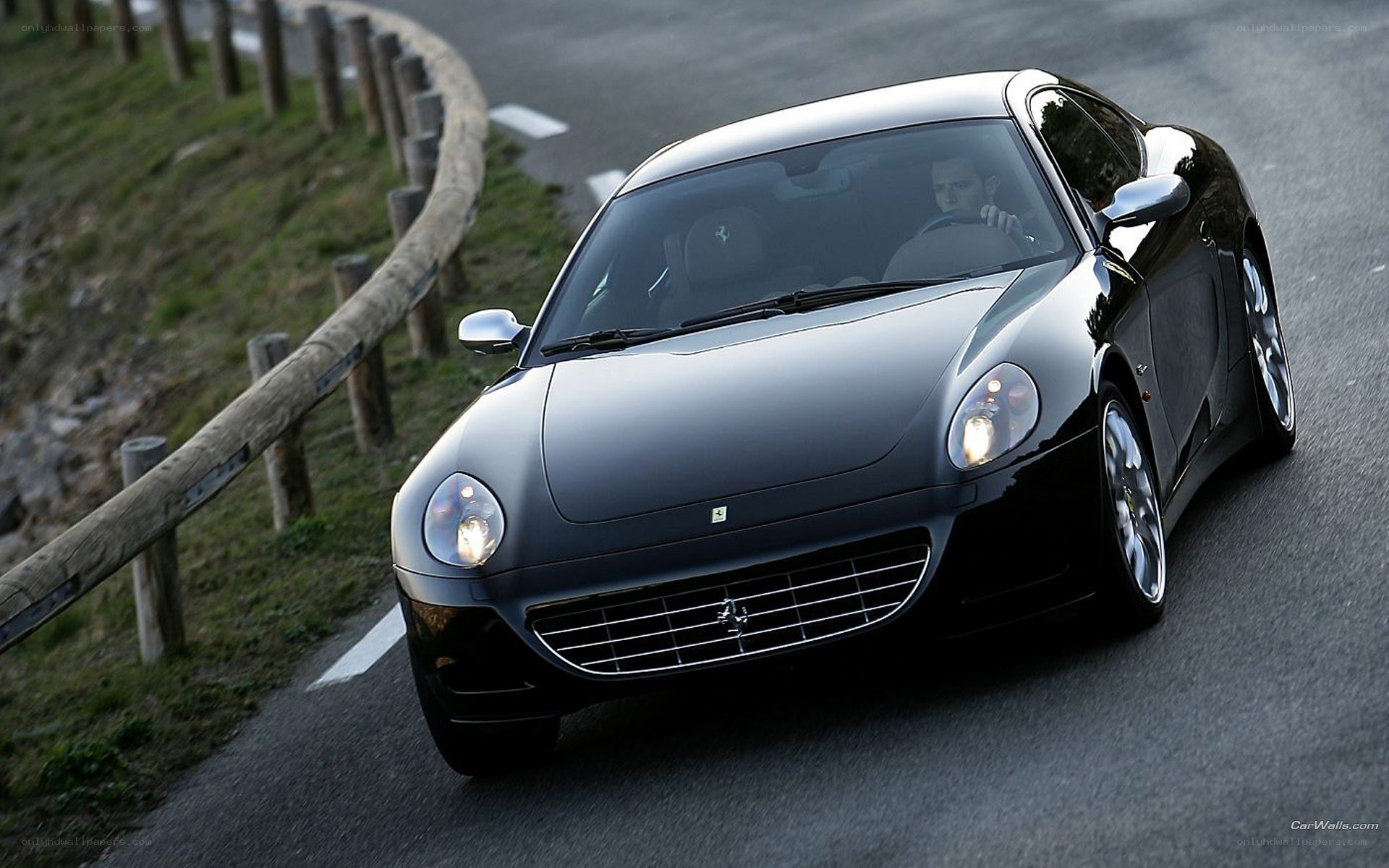 Black Ferrari driving on road