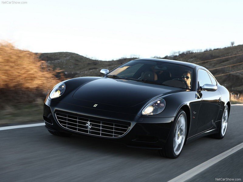 black ferrari driving on road
