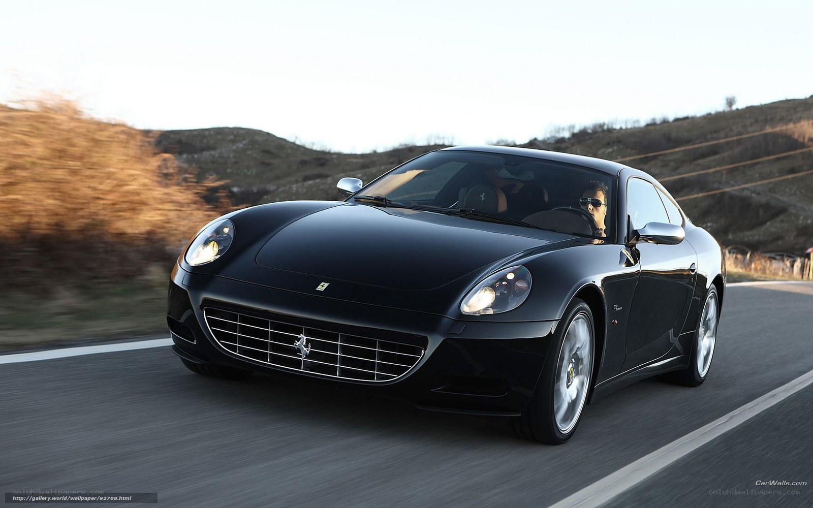 Black Ferrari driving on road