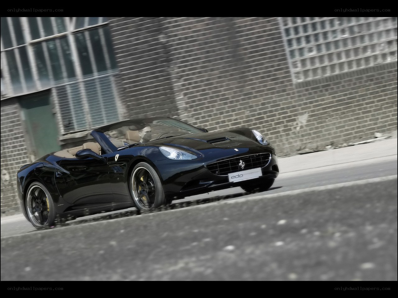 Black Ferrari driving on street