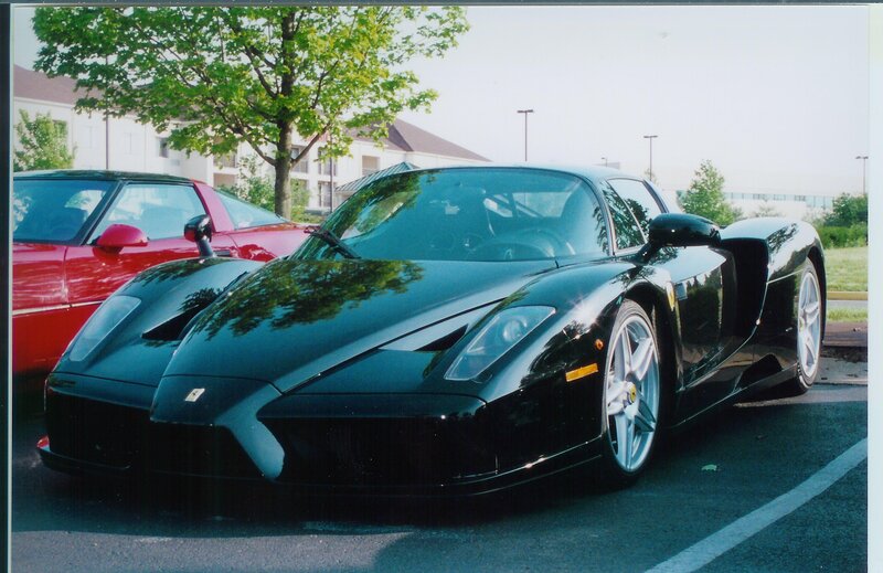 Black Ferrari Enzo in parking lot