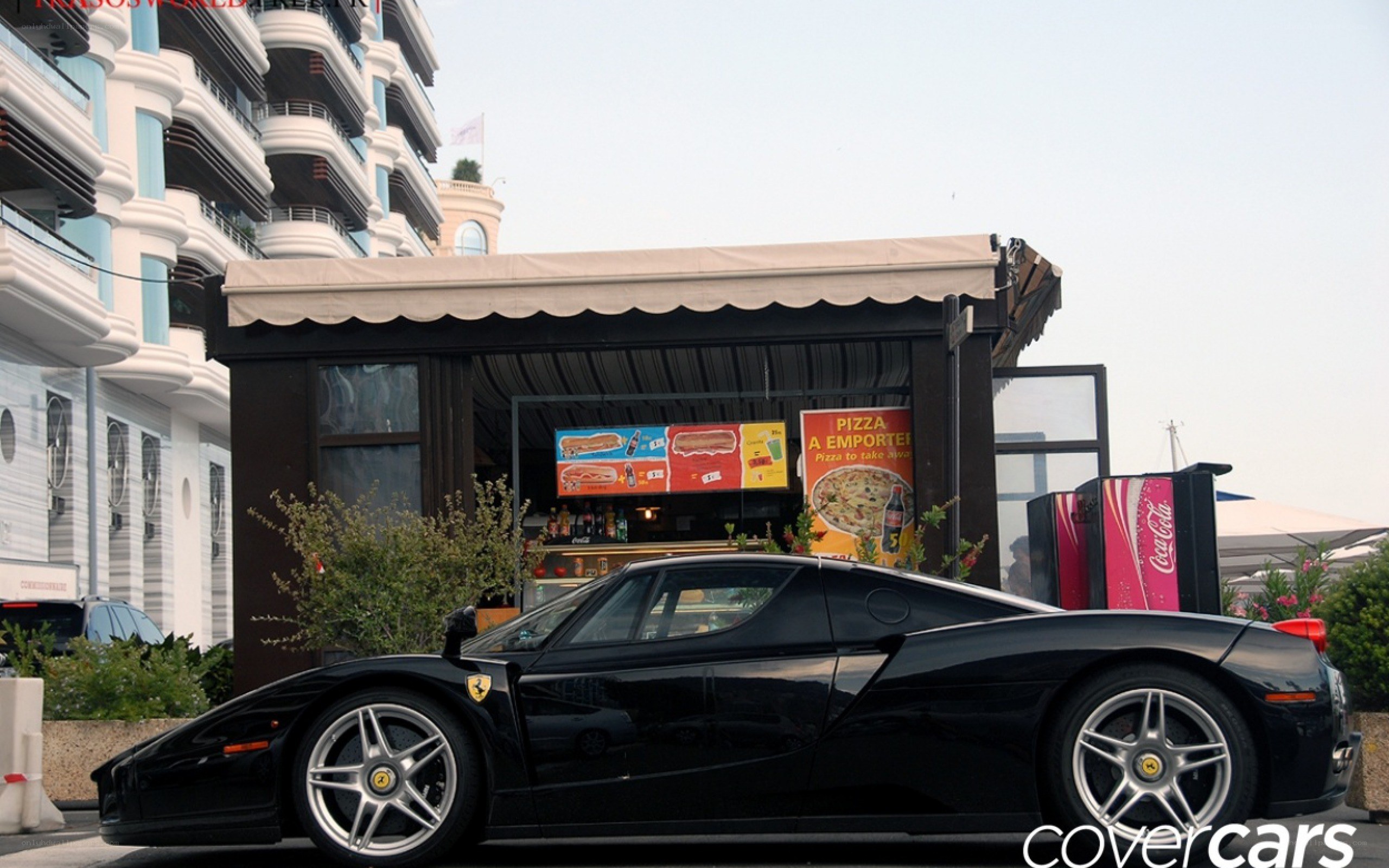 Black Ferrari Enzo parked outside
