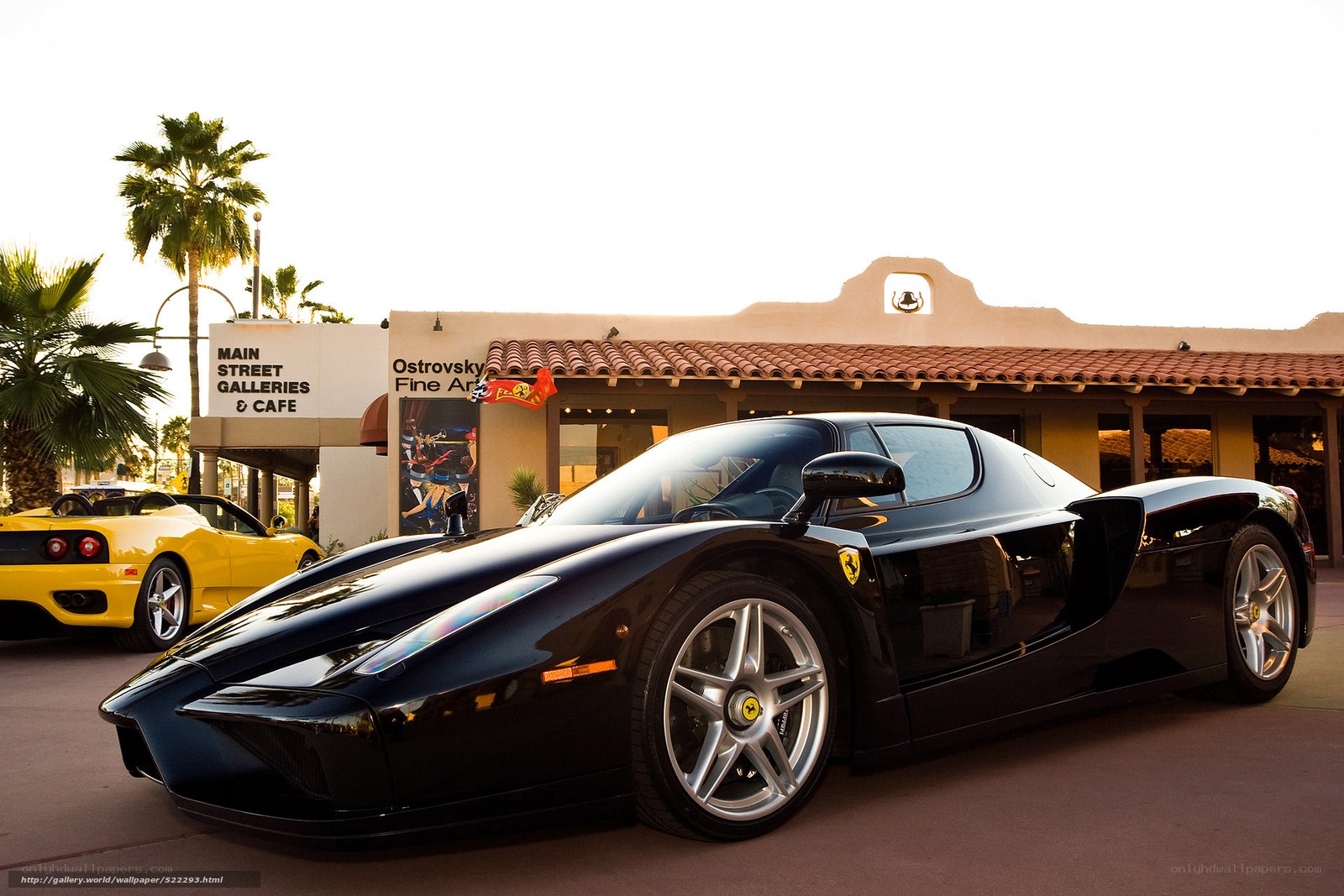 Black Ferrari Enzo parked outside gallery