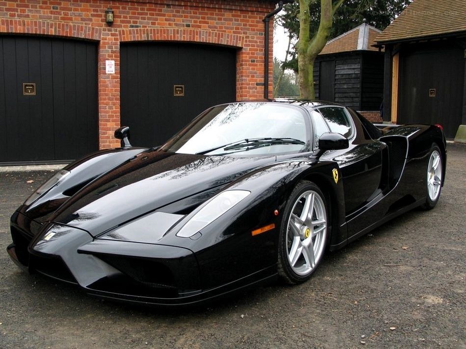 Black Ferrari Enzo parked outside