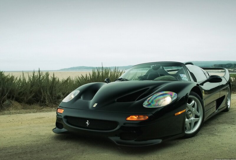 Black Ferrari F50 on a beach road