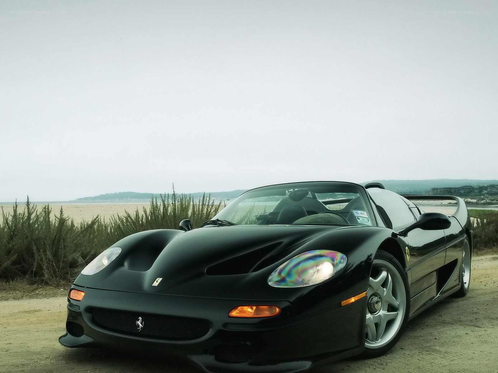 Black Ferrari F50 on a beach