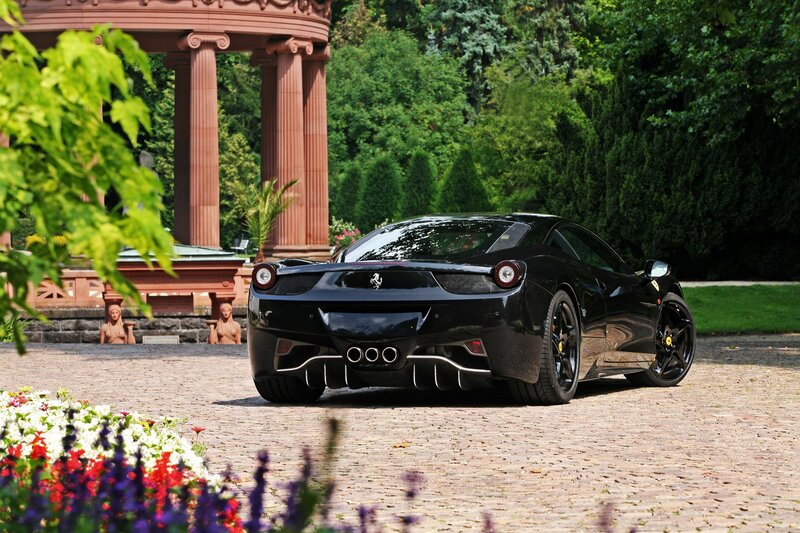 Black Ferrari in a garden