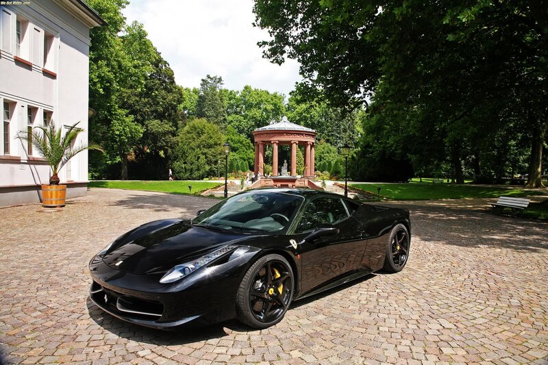 Black Ferrari in a garden