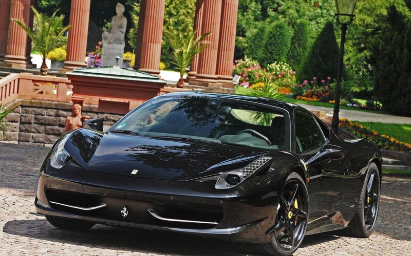 Black Ferrari in a garden