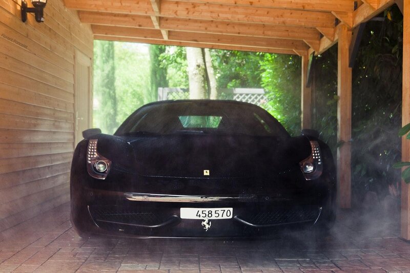 Black Ferrari in a wooden garage