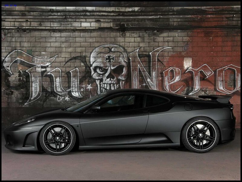 Black Ferrari in front of graffiti wall
